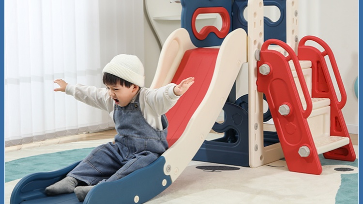 Little boy playing on indoor slide